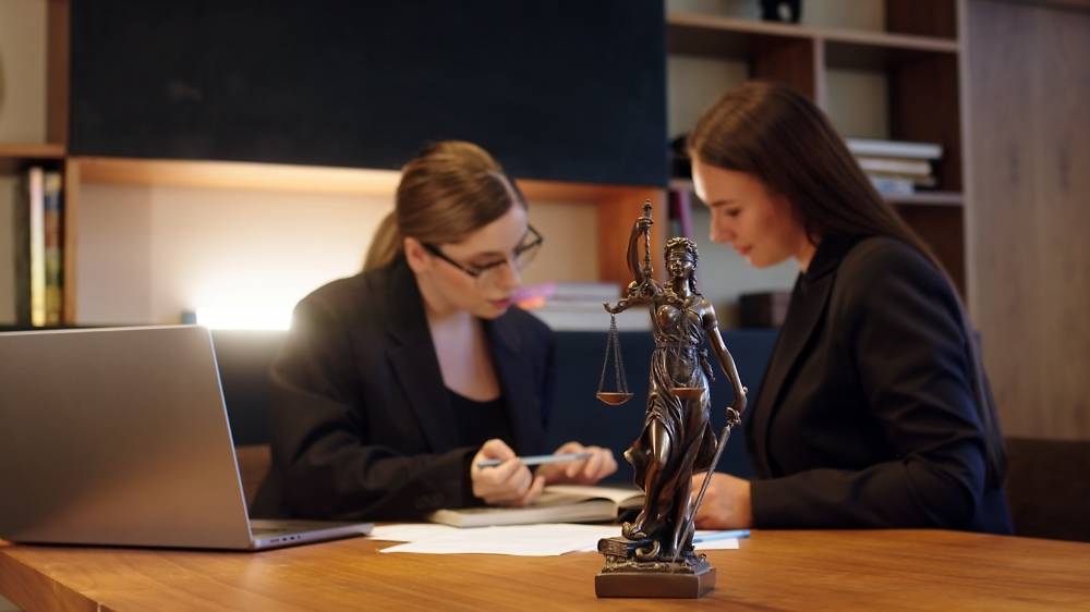 Mains classant des pièces d'un dossier juridique physique sur un bureau